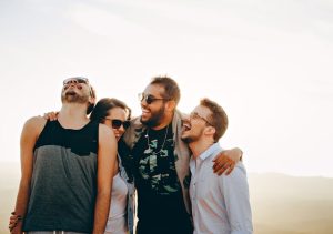 estate planning for blended families, image of four young adults laughing together outdoors