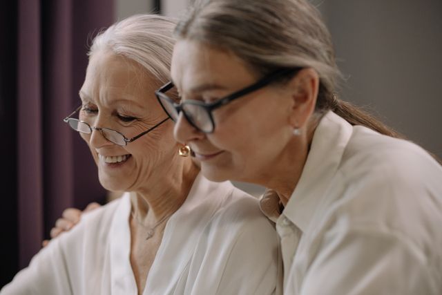Funding Your Living Trust, image of two senior women looking at something held on one of their hands